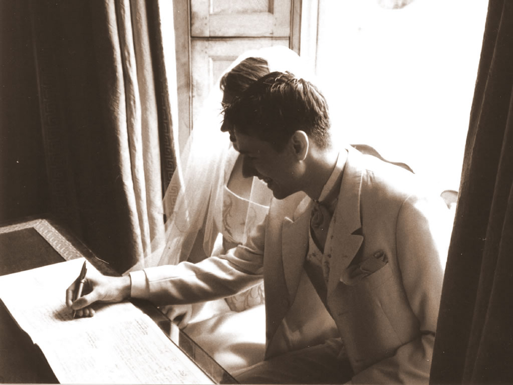 Charlotte & Tom pretending to sign the register